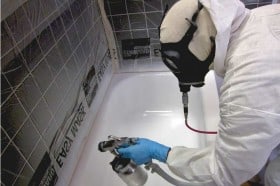 Bathtub refinishing professional refinisher spraying a tub