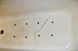 Cracked tub repair holes drilled for foaming.