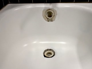 Bathtub drain overflow rust hole repair.