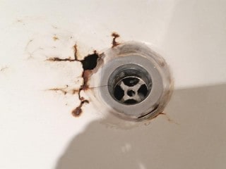 Bathtub drain rust thru with hole.