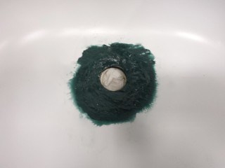 Bathtub drain rust hole filled with reinforced fiberglass gel.
