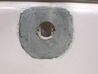 Bathtub overflow rust hole repair machined to flare to the tub.
