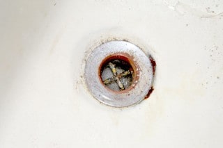 Old worn out tub drain. 