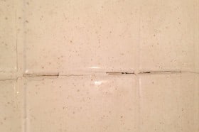 Refinished tile where the grout was not prepped or filled in magnifying the problem.