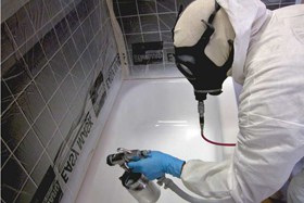 Technician spraying a bathtub