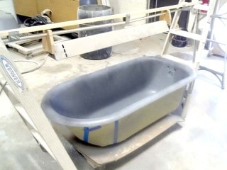 Inside of clawfoot tub being prepped.