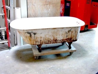 Rusted worn out clawfoot tub.