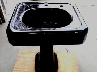 Black pedestal sink refinishing mounted on it's base.