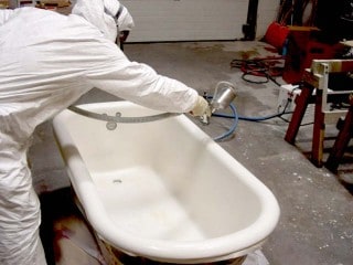 Tech refinishing clawfoot tub.