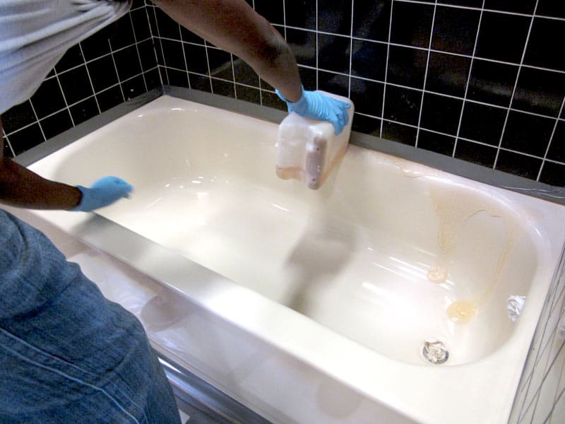Tech applying chemical stripper to peeling tub.